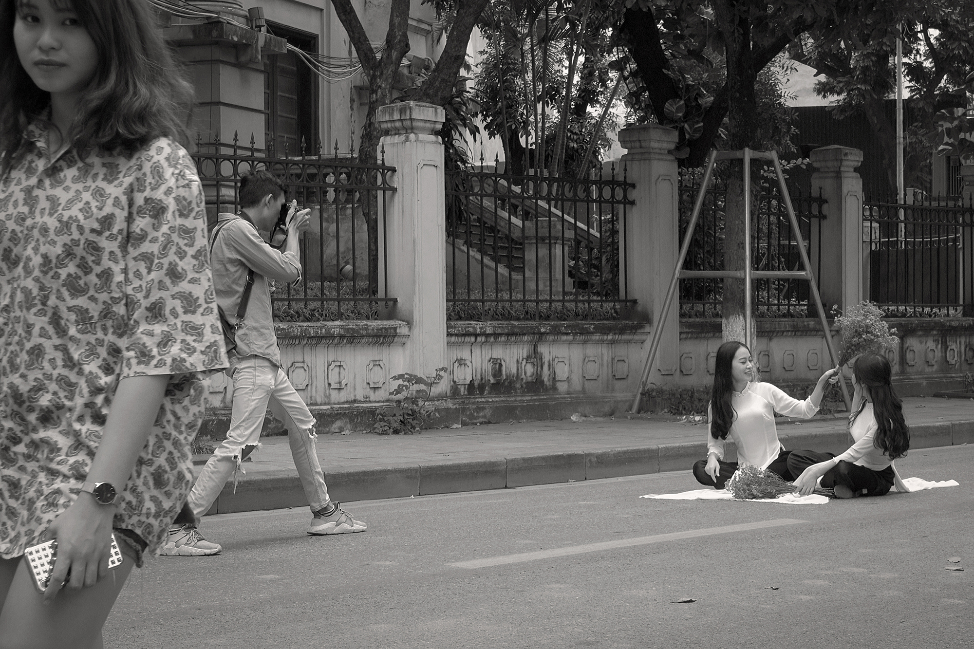 Christoph Radke, Vietnam, Hanoi, zwei junge auf der Straße sitzende Frauen werden fotografiert, 2018